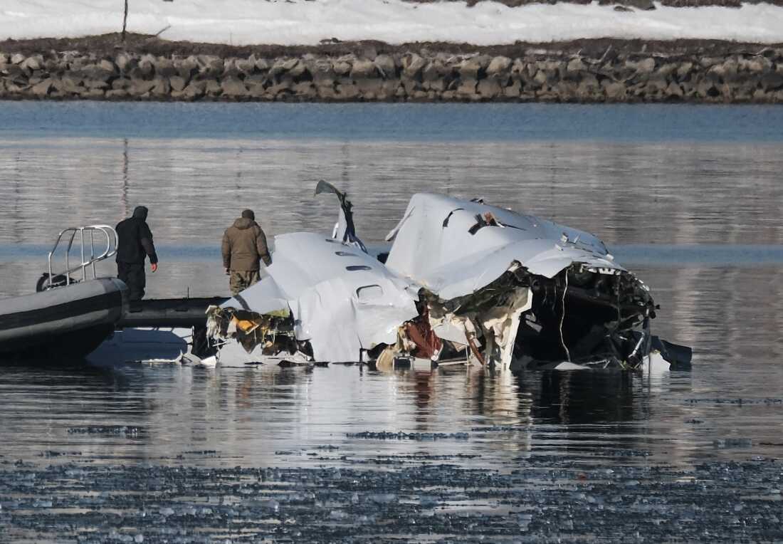 First responders search the crash site of American Airlines flight 5342 along the Potomac River on January 30, 2025. The American Airlines flight was inbound from Wichita, Kansas when it collided in midair with a U.S. Army Blackhawk helicopter (UH-60). According to reports there were no known survivors among the 67 passengers on both from both aircraft. Michael A. McCoy for NPR)